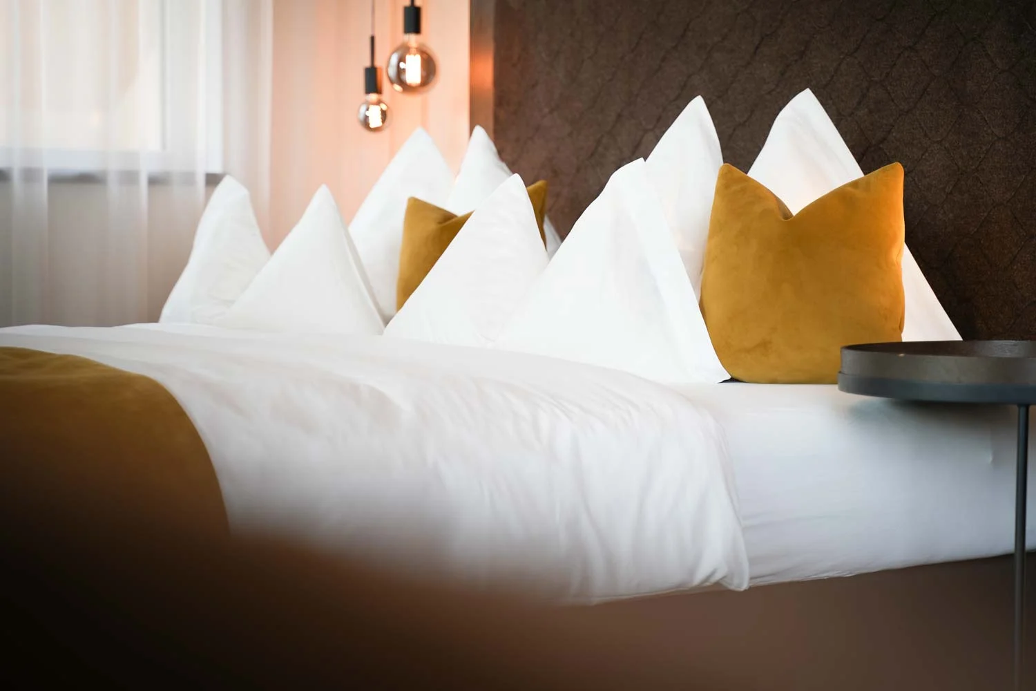 Appius Design Suites Appiano Bolzano hotel room with velvet pillows and blankets bs chairs —