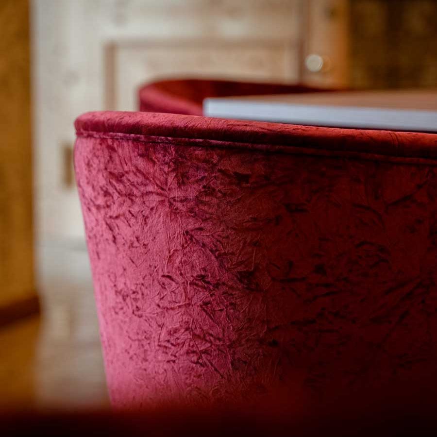 Design nell'Hotel Carlomagno: Poltroncine "Nashville" bordeaux per un'atmosfera di lusso e comfort