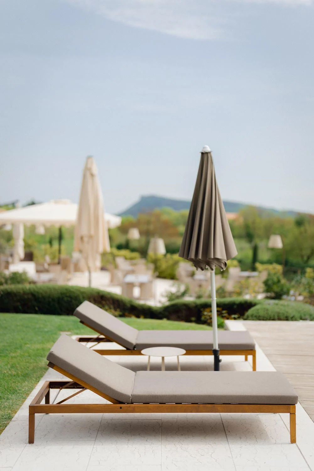 Relais Rossar outdoor pool with iroko loungers and chairs — interior design, furnishings